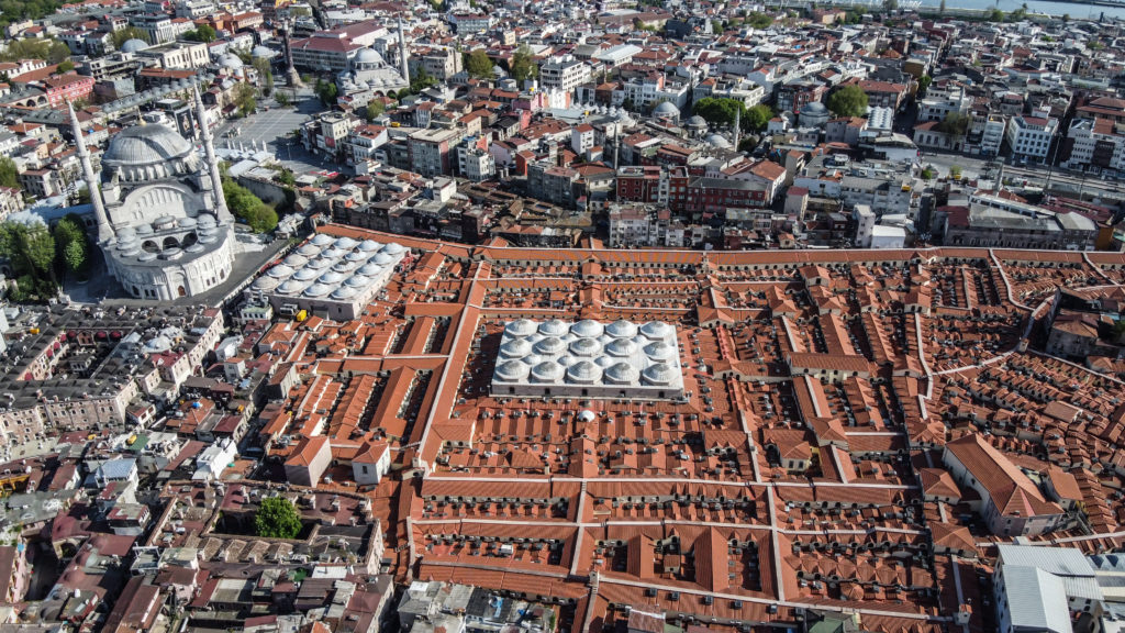 Aerial View of the Grand Bazaar - The domes of the Cevahir Bedesten (center) and the Sandal Bedesten (top left) stand out against the red roofs of the rest of the Bazaar.