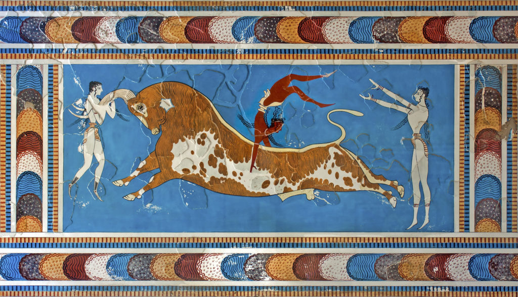 The famous bronze age Bull-leaping fresco.  A leaping man appears to be grappling a galloping bull against a brilliant blue backdrop.  Two figures stand on either side of the bull, one of which is holding its horns.