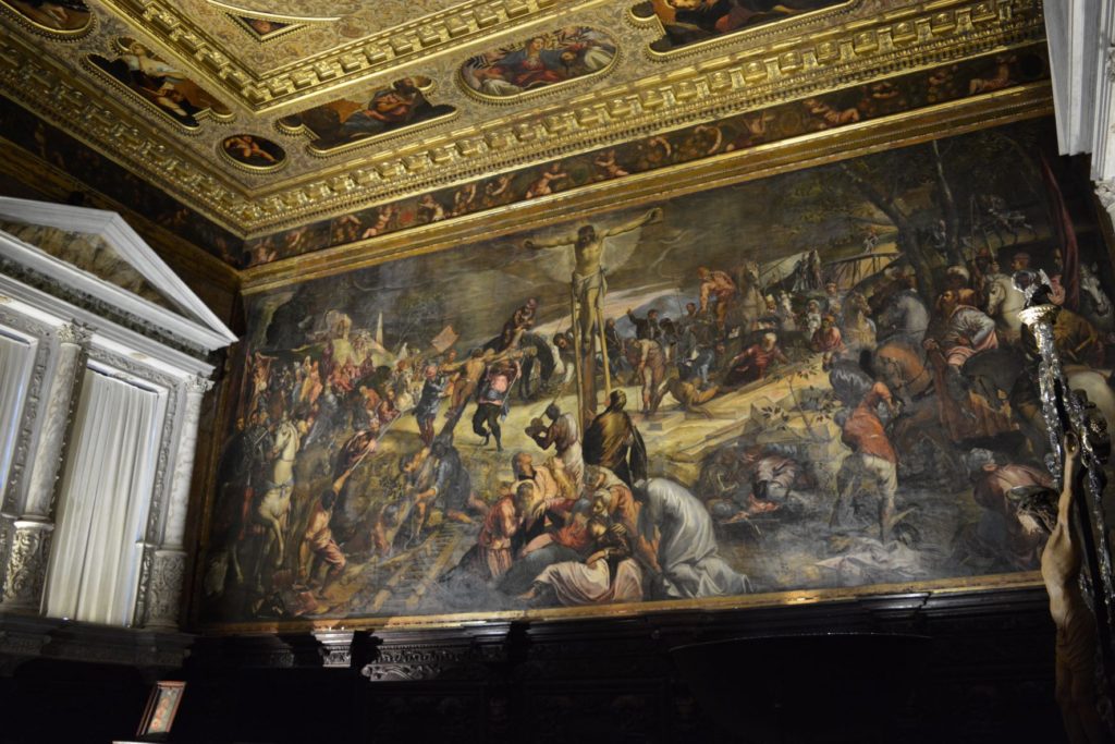 Image of the Crucifixion by Tintoretto together with some of the sumptuous decoration which surrounds the painting in the albergo of the Scuola di S. Rocco.